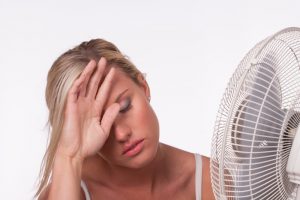 women using a fan because she is hot