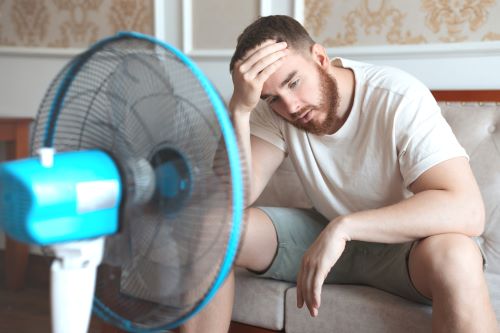 man with fan - broken ac